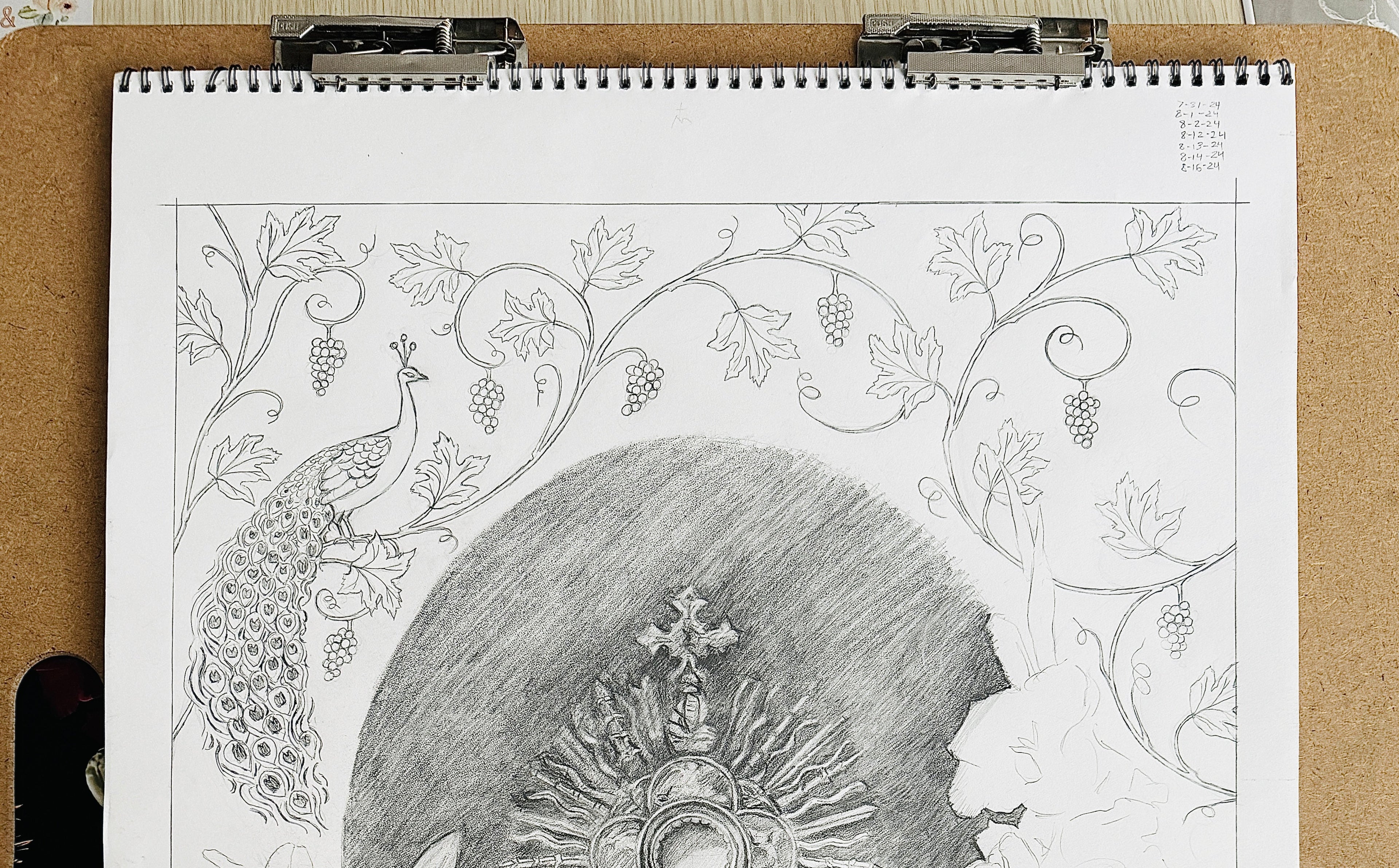 Pencil drawing of the Holy Eucharist surrounded by grape vines and a peacock on a drawing sheet of paper by Sacred Artist Maria Rangel Cardenas